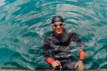 Triathlete swimmer portrait wearing wetsuit on training