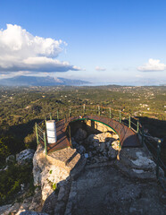 View of Kaiser's Throne observation deck lookout, Pelekas village, Corfu island, Greece, Kaiser William II summit Observatory panoramic summer view with mountains and Kerkyra in the background