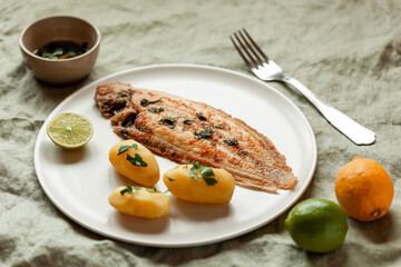 Fried sole fish served with boiled potatoes and parsley sauce