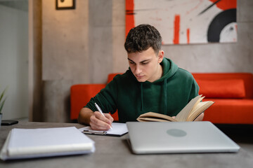 Young man caucasian teenager read book study at home education concept