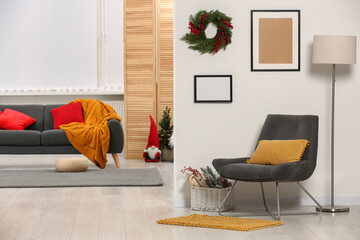 Comfortable furniture in stylish room decorated for Christmas. Interior design