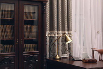 Library reading room interior with wooden bookcase and table near window