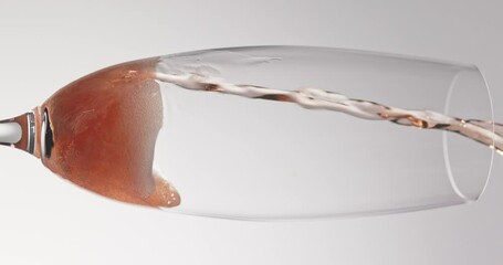pink sparkling wine pouring in to glass close up slow motion