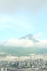 Picturesque view of cityscape with many buildings near mountain
