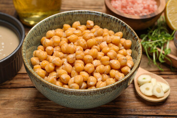 Delicious chickpeas on wooden table, closeup. Hummus ingredient
