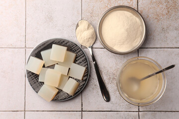Agar-agar jelly and powder on tiled surface, flat lay