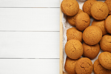 Delicious oatmeal cookies on white wooden table, top view. Space for text