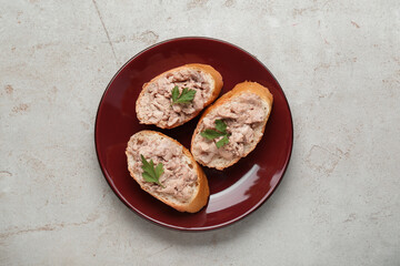 Tasty sandwiches with cod liver on light grey table, top view