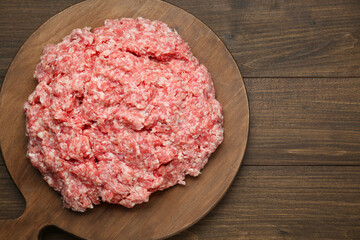 Raw fresh minced meat on wooden table, top view. Space for text