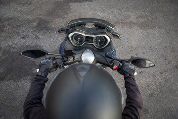 Fototapeta premium Top view of a biker riding his motorcycle, photo with copy space.
