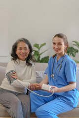 Fototapeta premium Female doctor taking a history of a patient and counseling on orthopedic diseases with female patients after measuring blood pressure and heart rate in a medical facility