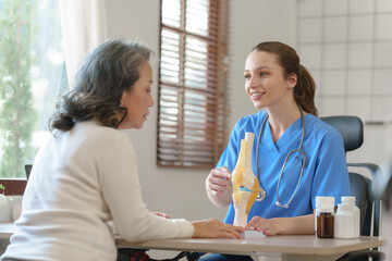 Female doctor taking a history of a patient and counseling on orthopedic diseases with female patients after measuring blood pressure and heart rate in a medical facility