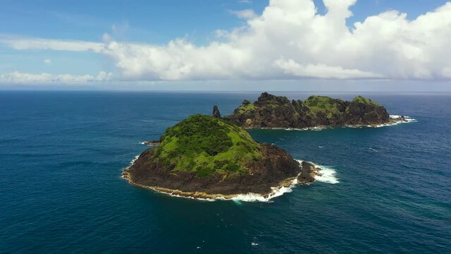 Top view of rocky tropical island in the blue ocean. Dos Hermanos Island. Santa Ana, Cagayan. Philippines.