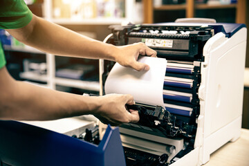 Technician hand open cover photocopier or photocopy to fix repair copier paper jam and replace ink...