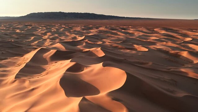 Aerial flyover sand dunes Khongoryn in Gobi desert in Mongolia.