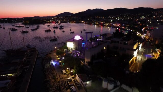 Night drone view of boats and Bodrum houses in Bodrum bay