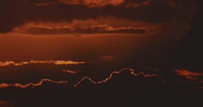 4K sunrise timelaps, big sun close up rising time lapse, through clouds highlight edge, beautiful cloudscape nature background in California