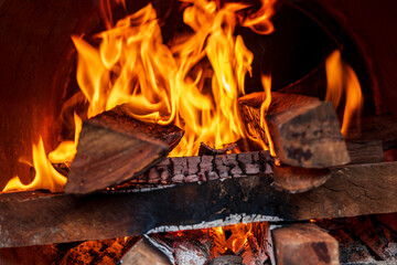 Close up shot of burning firewood in the fireplace. - 565510435