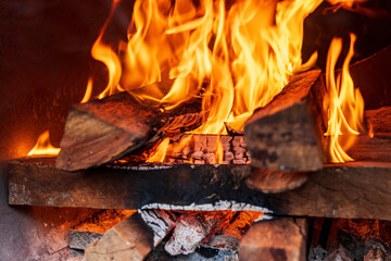 Close up shot of burning firewood in the fireplace. - 565510452