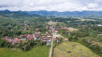 Aerial view of panorama of beautiful countryside of Bukittinggi. wonderful springtime landscape in mountains. grassy field and rolling hills. rural scenery. 