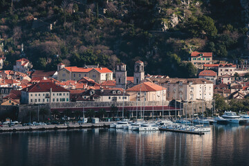 Kotor, Montenegro, beautiful top panoramic view of Kotor city old medieval town seen from San Giovanni St. John Fortress, with Adriatic sea, bay of Kotor and Dinaric Alps mountains in a sunny day