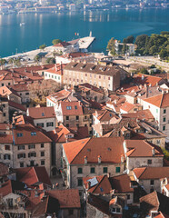 Kotor, Montenegro, beautiful top panoramic view of Kotor city old medieval town seen from San Giovanni St. John Fortress, with Adriatic sea, bay of Kotor and Dinaric Alps mountains in a sunny day