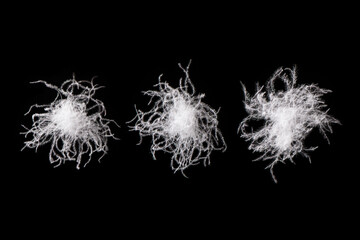 close up of white down feather on black background.	
