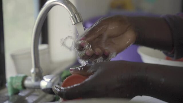 African hands washing dishes