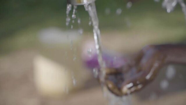 Washing Hands by a water pump