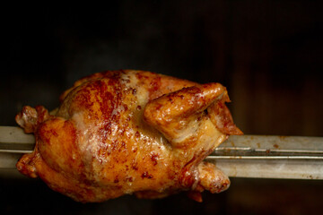 photograph of grilled chicken cooking in an oven. Typical Peruvian food. Food concept, oven and...