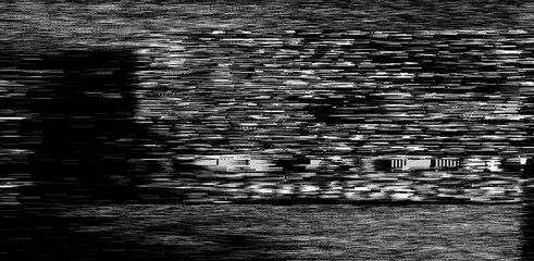 Black and white static noise of a TV screen. Glitched and distorted background.