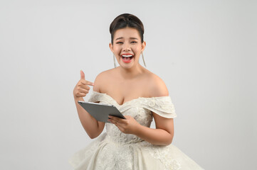 Young asian beautiful bride pose with tablet in hand