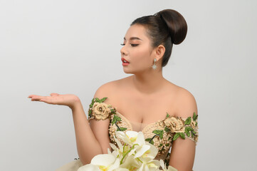 Young asian beautiful bride with orchid bouquet on white background