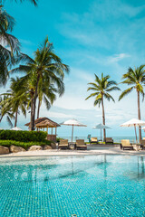 Beautiful tropical beach and sea with umbrella and chair around swimming pool in hotel resort - obrazy, fototapety, plakaty