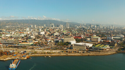 Fototapeta premium Cityscape: Cebu city with modern buildings, skyscrapers and business centers, top view during sunrise. Philippines.