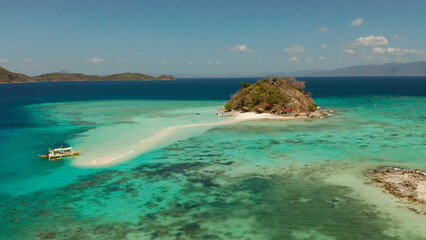 aerial seascape tropical island and sand beach, turquoise water and coral reef. malacory island, Philippines, Palawan. tourist boats on coast tropical island.