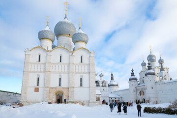 Assumption Cathedral and Resurrection Church in the Rostov Kremlin on January afternoon. Golden...