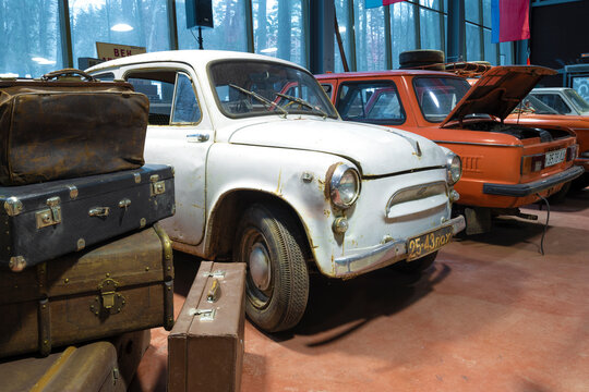 ZELENOGORSK, RUSSIA - JANUARY 27, 2021: Old Zaporozhets ZAZ-965 peeks out from behind a pile of old suitcases. Museum of retro cars "Horsepower"