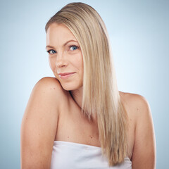 Obraz premium Skincare, beauty and portrait of a woman with hair care isolated on a blue background in a studio. Spa, wellness and cosmetology model with facial makeup, cosmetics and dermatology on a backdrop