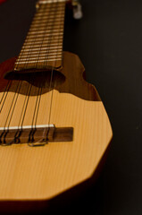 Obraz premium Charango, an Andean stringed instrument in black background.