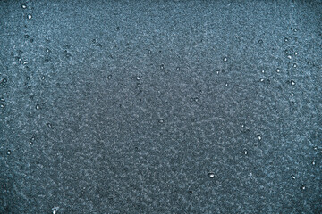 Macro of car glass window covered with ice and snow. Concept of bad visibility during freezing weather conditions.