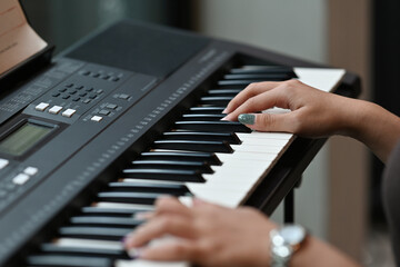 Close up with Asian musician woman's hand playing electone.