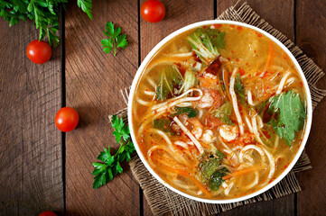 Thai soup with Prawns on a wooden table