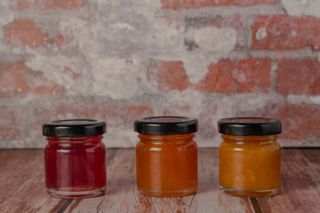 three jars of marmalade of different flavors