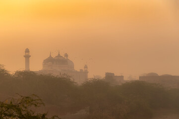 an old historical  fort in fog, landscape with fog and historical buildings in the desert