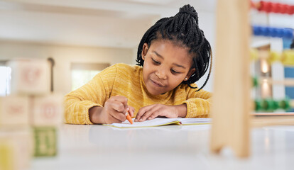 Education, girl and child writing at table for homework, lesson and home school activity in her...