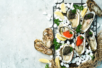 Caviar and oysters. Healthy food, gourmet food, restaurant food. On a gray concrete background. Top...