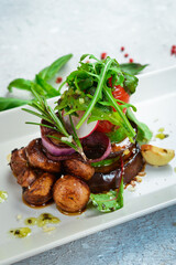 Grilled vegetables on a plate, restaurant serving of food. Eggplant, mushrooms, zucchini and tomatoes. Top view. Free space for text.