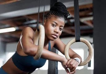 Zelfklevend Fotobehang Break, gymnastics and portrait of a black woman with rings for training, muscle and arms at gym. Focus, strong and face of an African gymnast with performance during a workout or exercise at a club © J Maas/peopleimages.com
