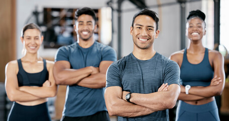 Fitness, portrait and man personal trainer with clients standing with crossed arms in the gym....